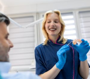 dentist showing dental prosthetics